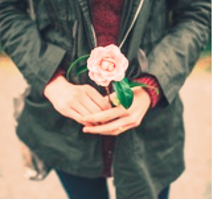 a woman holding a rose